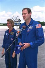 STS-94 Pilot Susan Leigh Still watches as Commander James D. Halsell, Jr., speaks to the media after the crew arrived at the Shuttle Landing Facility at Kennedy Space Center  ca. 1997
