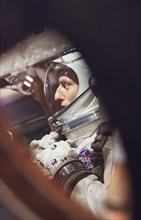 (21 Aug. 1965) --- View of astronaut Charles Conrad Jr. through the window as he sits in the Gemini-5 spacecraft during preflight activities