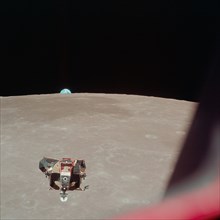 (21 July 1969) --- The Apollo 11 Lunar Module (LM) ascent stage, with astronauts Neil A. Armstrong and Edwin E. Aldrin Jr. onboard, is photographed from the Command and Services Modules (CSM) in lunar...