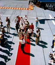 (29 Aug. 1965) --- Astronauts L. Gordon Cooper Jr. (right center), Gemini-Titan 5 and Charles Conrad Jr., pilot, receive a red-carpet welcome as they arrive aboard the aircraft carrier USS Lake Champl...