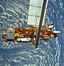 This STS-48 onboard photo is of the Upper Atmosphere Research Satellite (UARS) in the grasp of the RMS (Remote Manipulator System) during deployment, September 1991.