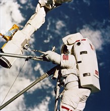 1992 - In this STS-49 onboard photo, Astronaut Kathryn Thornton joins three struts together during her Extra Vehicular Activity (EVA).