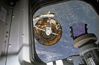 1992 - Recorded with a 35 mm camera inside Endeavour’s cabin, is astronaut Pierre Thuot after his second unsuccessful attempt to affix a specially designed grapple bar to the 4.5 ton INTELSAT VI.