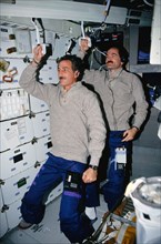 1990 - STS-35 MS Hoffman & Pilot Gardner "commute" to work on the middeck of OV-102