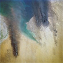 (28 April-6 May 1991) --- Kuwait Oil Fires - This view from the Earth-orbiting Space Shuttle Discovery shows the smoke from burning oil well fires, aftermath of Iraqi occupation.