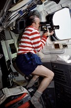 1991 - STS-43 Mission Specialist astronaut James Adamson uses camera on aft flight deck