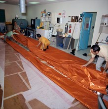 (18 May 1973) --- Workmen in the GE Building across the street from the Johnson Space Center fold a sail-like sunshade being fabricated for possible use as a sunscreen for the Skylab Orbital Workshop ...