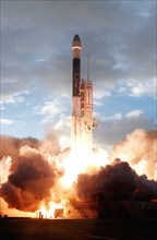 1998 - Lighting up the launch pad, a Boeing Delta II (7326) rocket propels Deep Space 1 through the morning clouds after liftoff from Launch Complex 17A, Cape Canaveral Air Station.