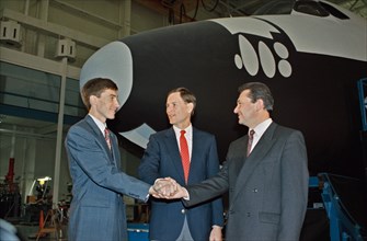 (10 Nov 1992) --- Russian cosmonauts Sergei Krikalev (left), and Vladimir Titov (right) share a team handshake with Kenneth L. Reightler, STS-60 pilot.