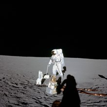 Astronaut Alan L. Bean, lunar module pilot, deploys components of the Apollo Lunar Surface Experiments Package (ALSEP) during the first Apollo 12 extravehicular activity (EVA) on the moon.