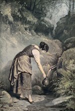 Junge Frau schöpft das Osterwasser am Brunnen