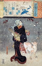 Woman and her dog during falling snow