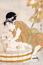 Mother bathing a child