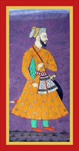 Khairat khan stands in a  flower-patterned orange tunic