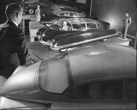 Plaster three-eighths size models of proposed new cars at the Detroit General Motors plant are evaluated for flaws. Detroit, Michigan, 1951.