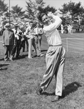 Professional golfer Byron Nelson driving a golf ball during an exhibition match. Circa 1940.
