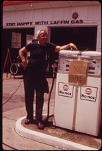 Gas station operator stands by empty gas pump during the height of the gas shortage, no location, 1973.