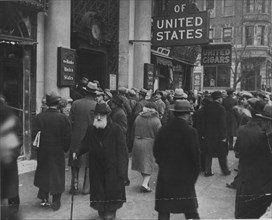Photograph of a crowd gathering outside the closed Bank of the United States on Freeman Street, New York, NY, 4/1931.