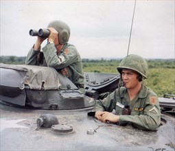 Army troops survey a forward area from the top of an M-48 during a road reconnaissance. Vietnam, Oct, 1965.