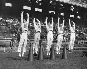 Cheerleaders lead the students in cheering for the team at the Maryland-Penn State game. College Park, MD,  9/25/50.