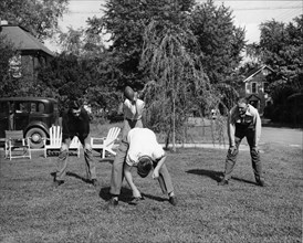 A father in Arlington, Virginia, Takes Time to Play Football with his Three Sons After Working Hours