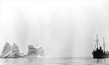Ship at sea near iceberg ca. 1910-1917