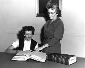 Photograph of Federal Register Staff Examining Voting Records ca. 1939 - 1968