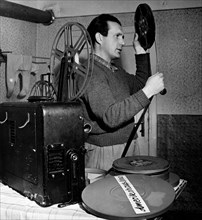 Herr Fichtl Checks film and projector at His Home ca. 1948-1954
