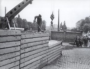 After The Wall Was Damaged at Acker, Corner Bernauerstrasse, Volksarmy Workers Are Fixing The Wall