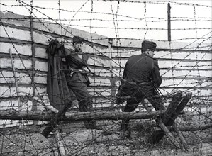 East German soldiers in front of largest wall built so far - The work crews erected five meters