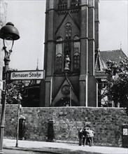 Berlin Wall along Bernauer Street blocks entrance to church in East Berlin symbolically reminding