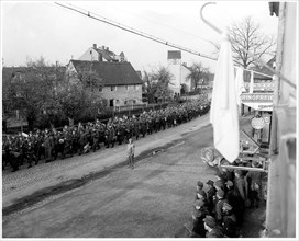 Original Caption: Surrender flag flies from civilian home in Chemnitz as more thousands of Nazi