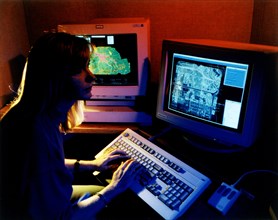 September 1996 - Scientist at computer analyzing multiple layers of data