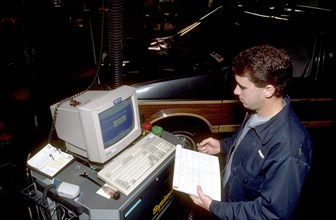 Technician performing an emissions test on a vehicle November 11, 1992