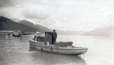 Title: View of Emil Colman aboard his boat on the Skeena River