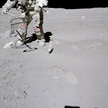 Astronaut John W. Young collects samples