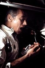 Eugene A. Cernan eating a meal under weightlessness conditions