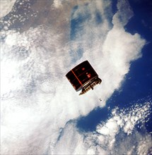 View of the Syncom IV satellite in orbit over the earth