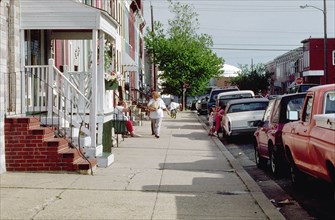 1998 - woman walking down sidewalk in urban setting