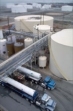 December 12, 1997 - gasoline tanker trucks after getting fuel at a gasoline storage facility
