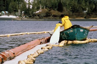 September 1996 - Worker checking oil-sorbent booms in Prince William Sound