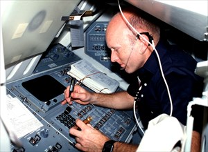 Pilot Fullerton, wearing communications kit assembly (assy) mini headset