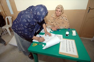An Afghan woman registers to vote