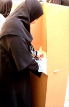 An Iraqi woman casts her vote