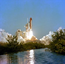 Space shuttle Columbia begins a new era of operational flights as it clears the launch tower