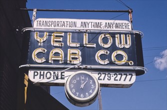 1990s United States -  Yellow Cab Co sign with clock