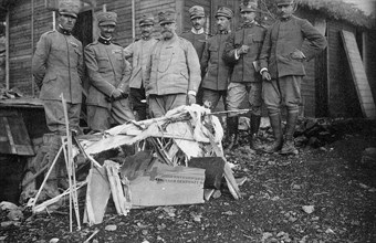Captain Baracca, 1st on the left, with the remains of an Austrian airplane he shot down