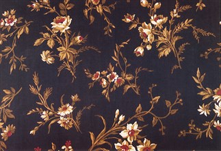 Floral pattern of light brown flowers with red centers.