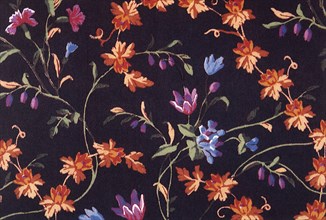 Orange and purple flower repeat pattern on dark background.