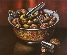 A bowl of walnuts and assorted nuts with nutcracker tools.